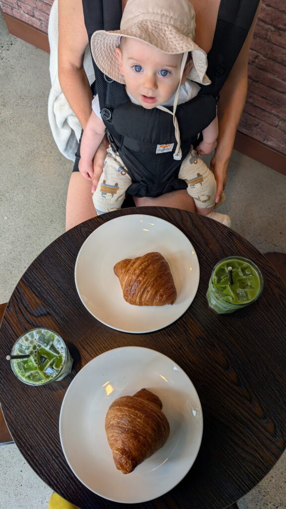 baby, matchas and croissants at a cafe