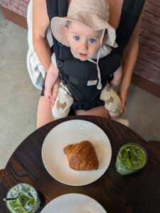 baby, matchas and croissants at a cafe