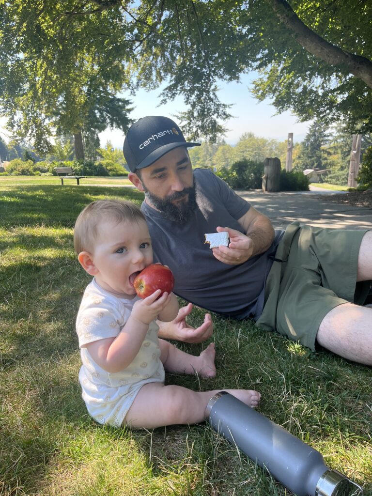 baby eating apple at burnaby mountain park